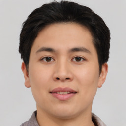 Joyful asian young-adult male with short  brown hair and brown eyes