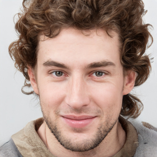 Joyful white young-adult male with short  brown hair and blue eyes