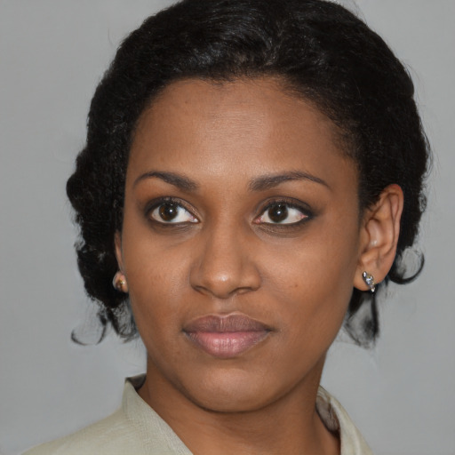 Joyful black young-adult female with medium  brown hair and brown eyes
