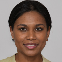 Joyful latino young-adult female with medium  brown hair and brown eyes