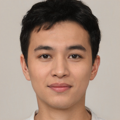 Joyful asian young-adult male with short  black hair and brown eyes