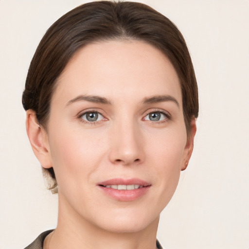 Joyful white young-adult female with short  brown hair and grey eyes