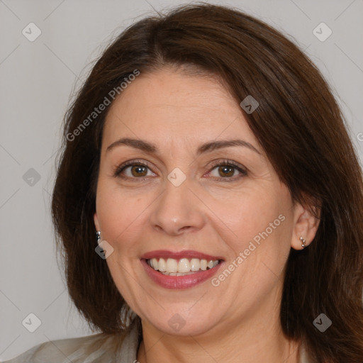 Joyful white adult female with medium  brown hair and brown eyes