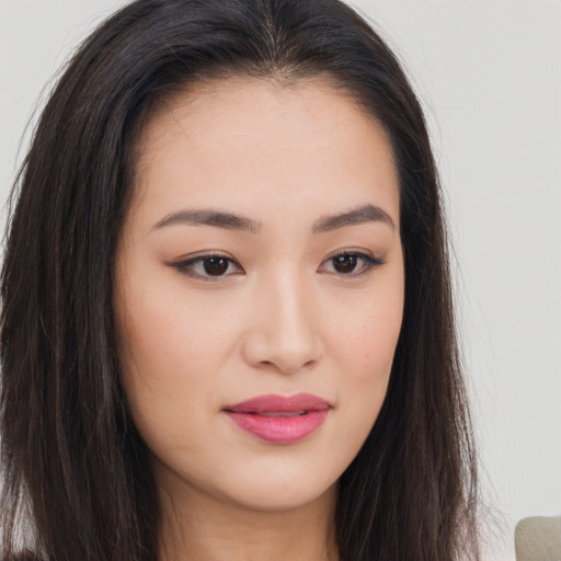 Joyful asian young-adult female with long  brown hair and brown eyes