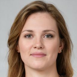 Joyful white young-adult female with long  brown hair and green eyes