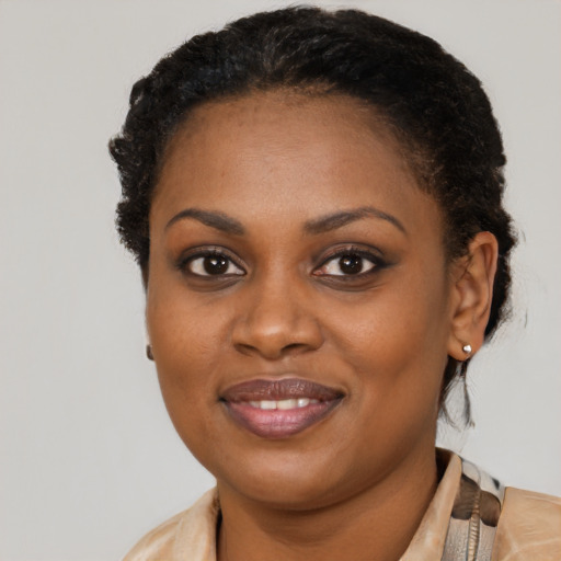 Joyful black young-adult female with short  brown hair and brown eyes