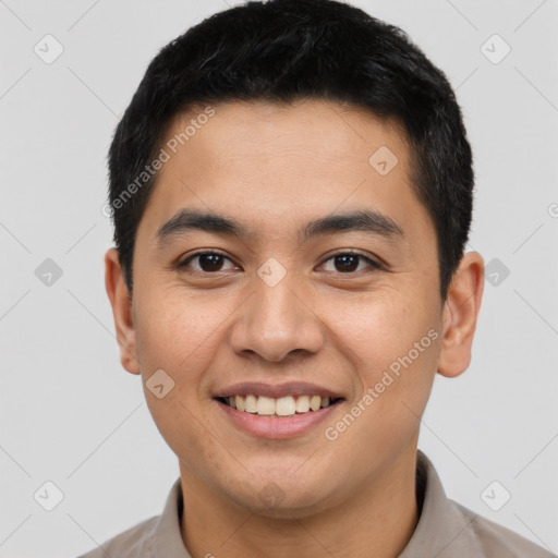 Joyful latino young-adult male with short  black hair and brown eyes