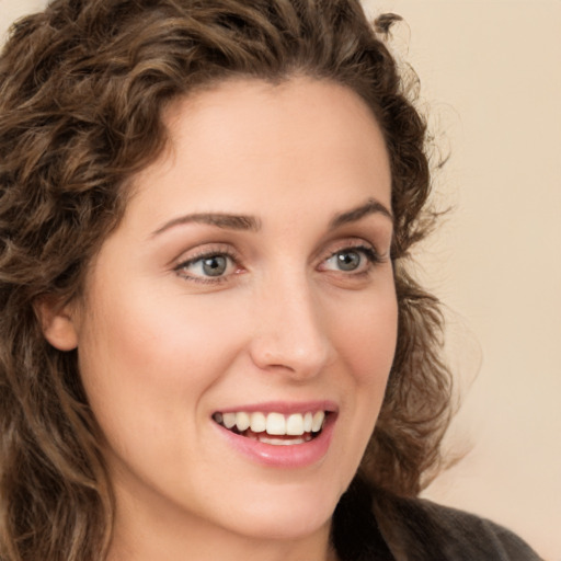 Joyful white young-adult female with long  brown hair and green eyes