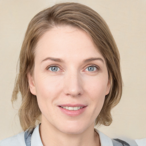 Joyful white young-adult female with medium  brown hair and blue eyes