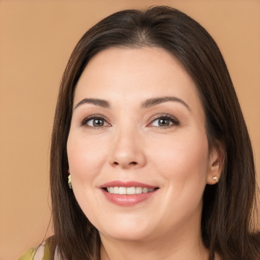 Joyful white young-adult female with long  brown hair and brown eyes