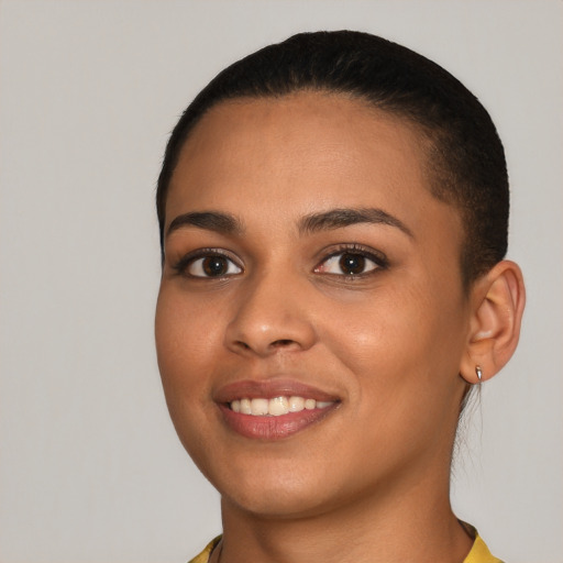 Joyful latino young-adult female with short  brown hair and brown eyes