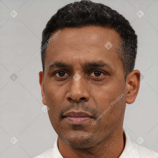 Neutral latino adult male with short  black hair and brown eyes