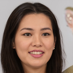 Joyful asian young-adult female with long  brown hair and brown eyes