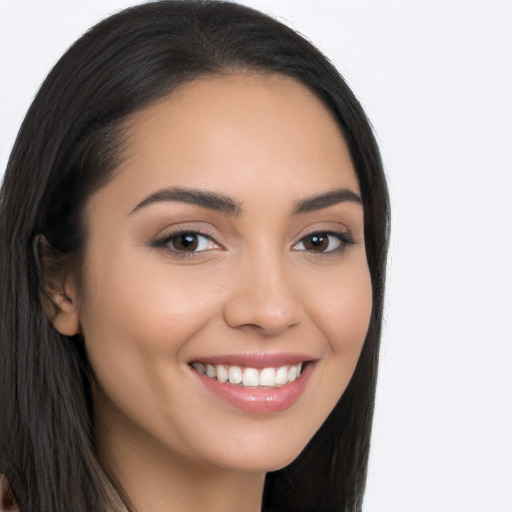 Joyful latino young-adult female with long  brown hair and brown eyes