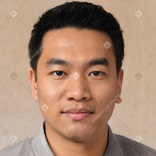 Joyful asian young-adult male with short  black hair and brown eyes