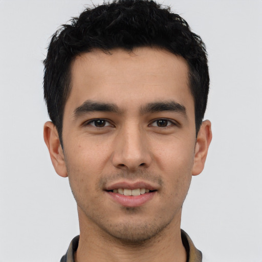 Joyful white young-adult male with short  black hair and brown eyes