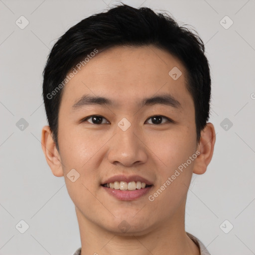 Joyful asian young-adult male with short  black hair and brown eyes