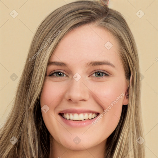 Joyful white young-adult female with long  brown hair and green eyes