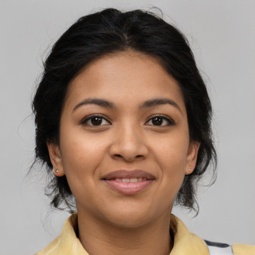 Joyful latino young-adult female with medium  brown hair and brown eyes