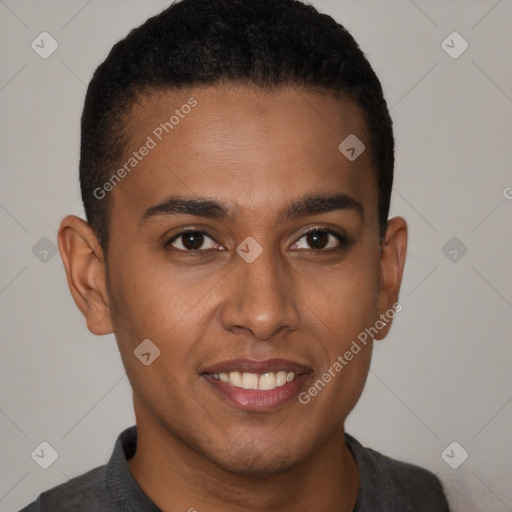 Joyful black young-adult male with short  brown hair and brown eyes