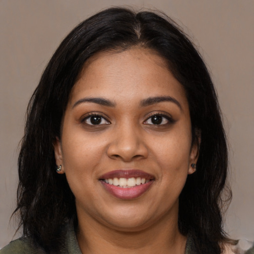 Joyful latino young-adult female with long  black hair and brown eyes