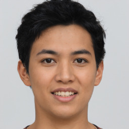 Joyful asian young-adult male with short  black hair and brown eyes