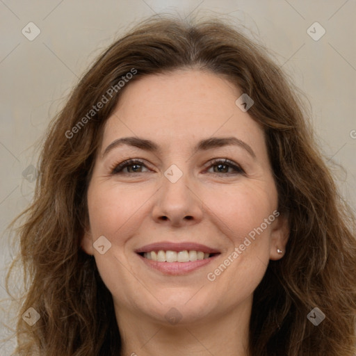 Joyful white adult female with long  brown hair and brown eyes