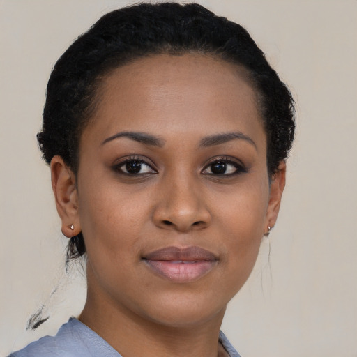 Joyful black young-adult female with short  brown hair and brown eyes