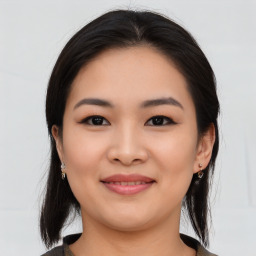 Joyful asian young-adult female with medium  black hair and brown eyes