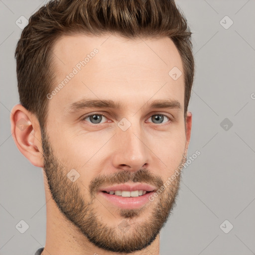 Joyful white young-adult male with short  brown hair and grey eyes