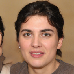 Joyful white young-adult female with medium  brown hair and brown eyes