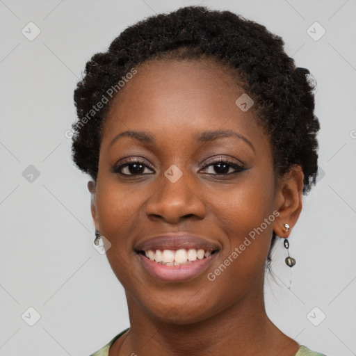 Joyful black young-adult female with short  brown hair and brown eyes