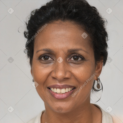 Joyful black adult female with short  brown hair and brown eyes