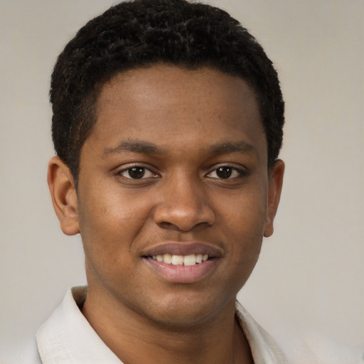 Joyful black young-adult male with short  brown hair and brown eyes