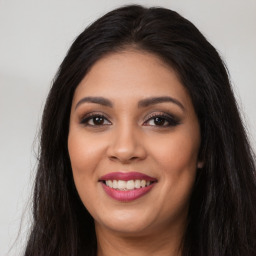 Joyful latino young-adult female with long  brown hair and brown eyes