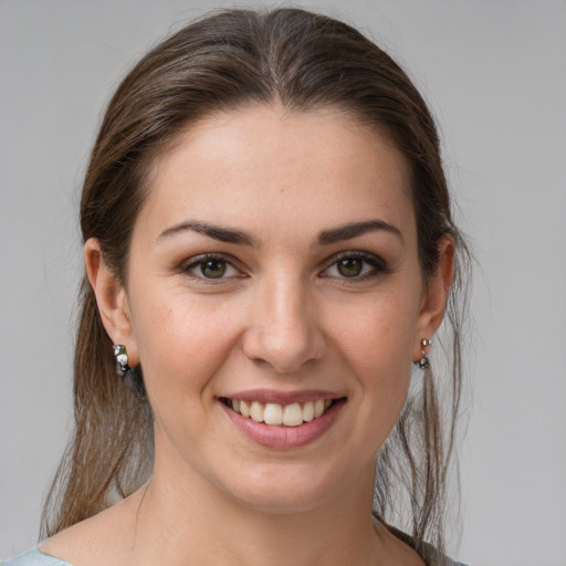 Joyful white young-adult female with medium  brown hair and brown eyes