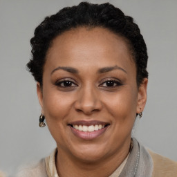 Joyful black adult female with short  brown hair and brown eyes