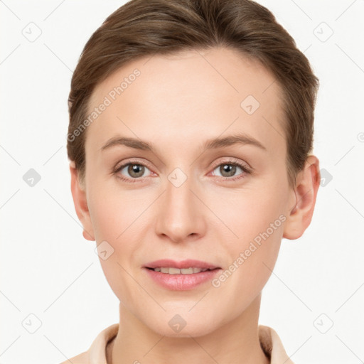 Joyful white young-adult female with short  brown hair and grey eyes