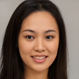 Joyful asian young-adult female with long  brown hair and brown eyes