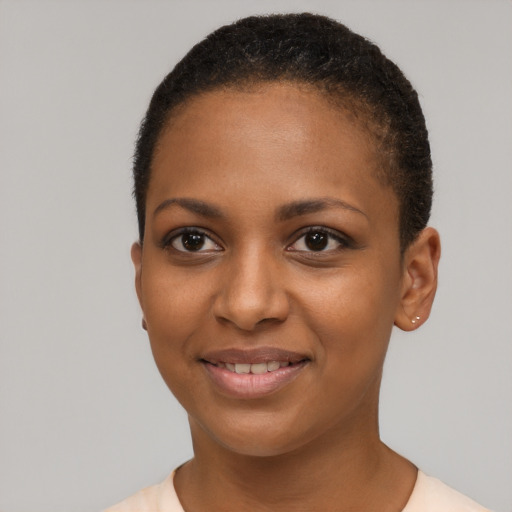 Joyful black young-adult female with short  black hair and brown eyes
