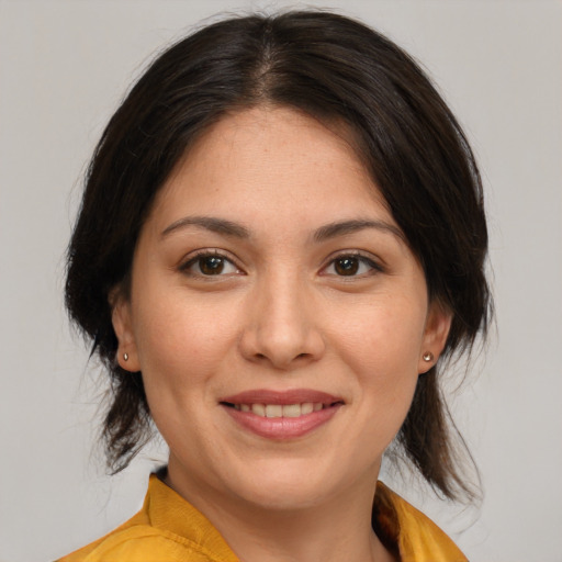 Joyful asian young-adult female with medium  brown hair and brown eyes