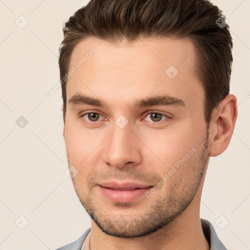 Joyful white young-adult male with short  brown hair and brown eyes