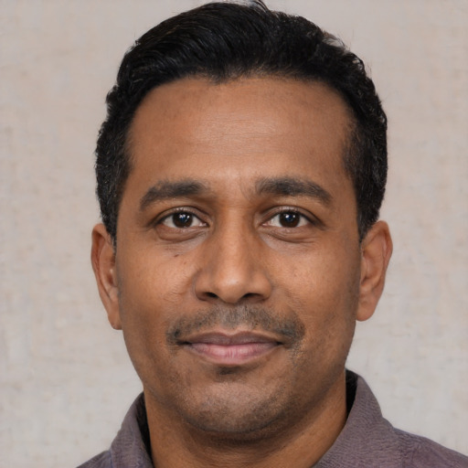 Neutral latino adult male with short  black hair and brown eyes