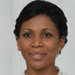 Joyful black adult female with short  brown hair and brown eyes