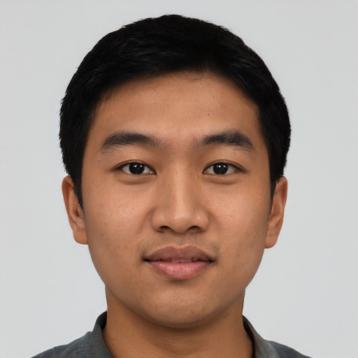 Joyful asian young-adult male with short  black hair and brown eyes