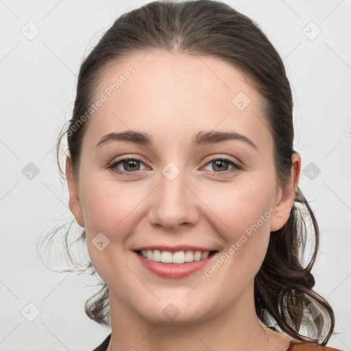 Joyful white young-adult female with medium  brown hair and grey eyes