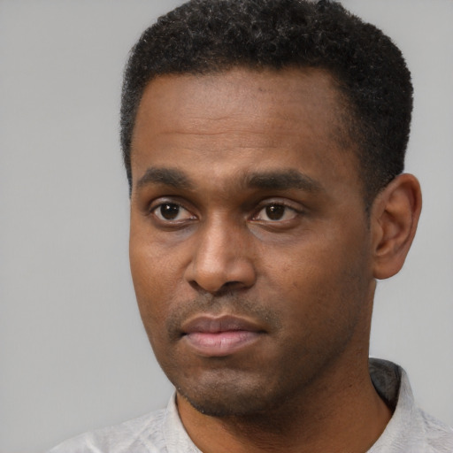 Neutral black young-adult male with short  black hair and brown eyes
