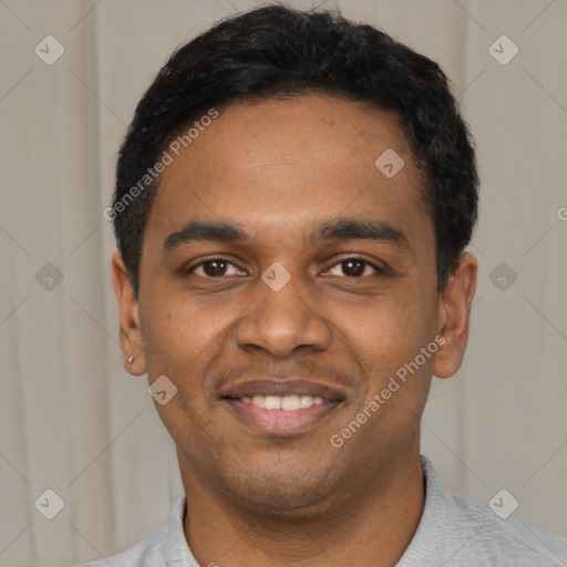 Joyful black young-adult male with short  black hair and brown eyes