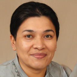 Joyful latino adult female with short  brown hair and brown eyes