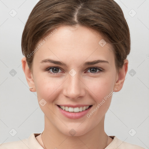 Joyful white young-adult female with short  brown hair and grey eyes